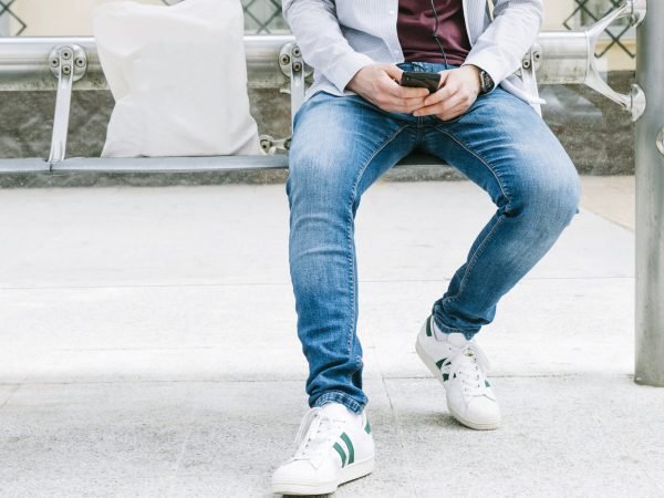 low-section-man-using-smartphone